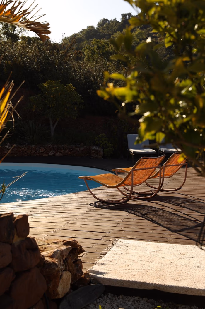 The swimming pool at Rose Mountain with garden chairs