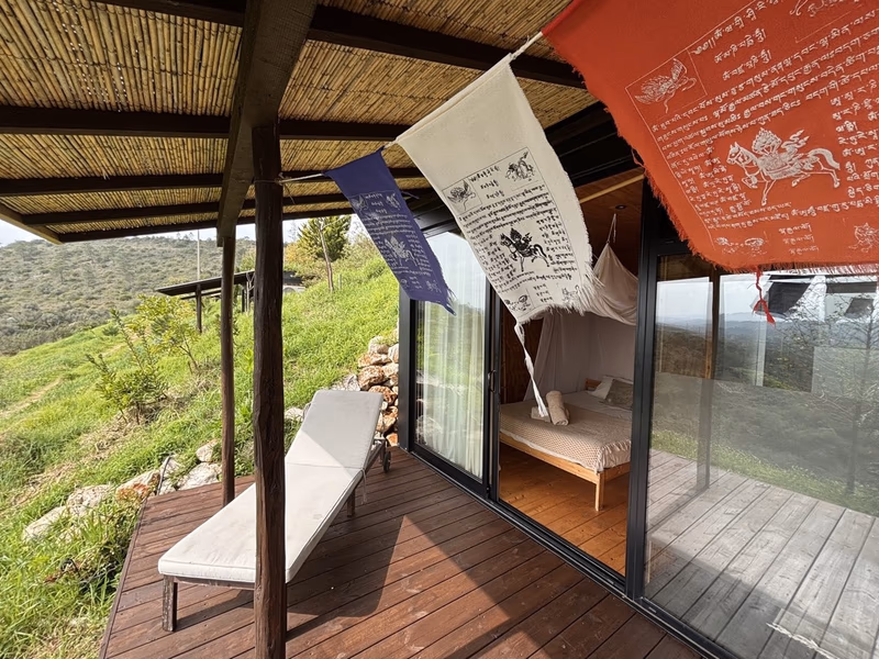 Tiny house veranda with prayer flags and valley views