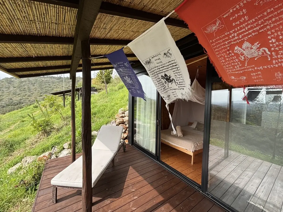 Tiny house veranda with Tibetan prayer flags at Rose Mountain