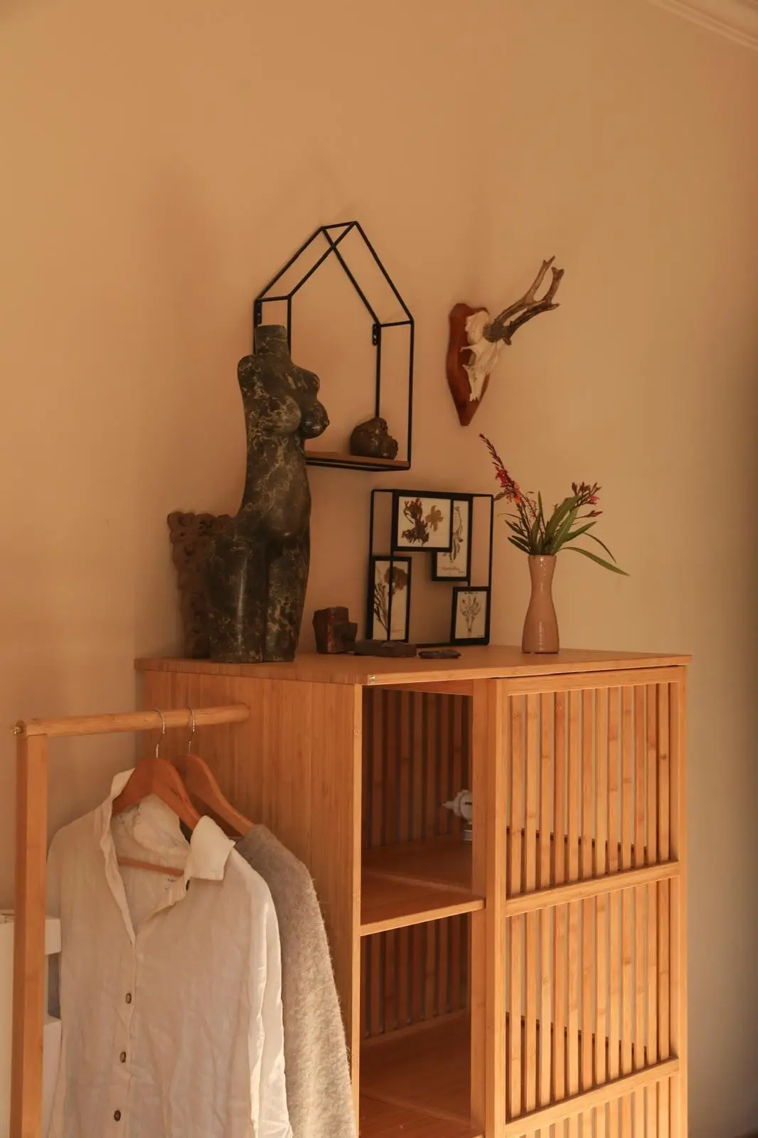 Villa room detail - sculpture, dried flowers and warm evening light